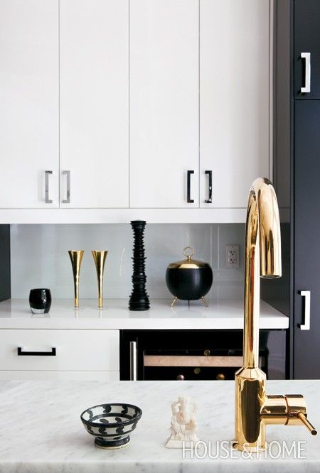 black and white kitchen with brass and chrome accents